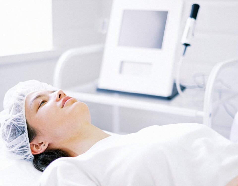 Woman in White Shirt Lying on Bed in the Clinic