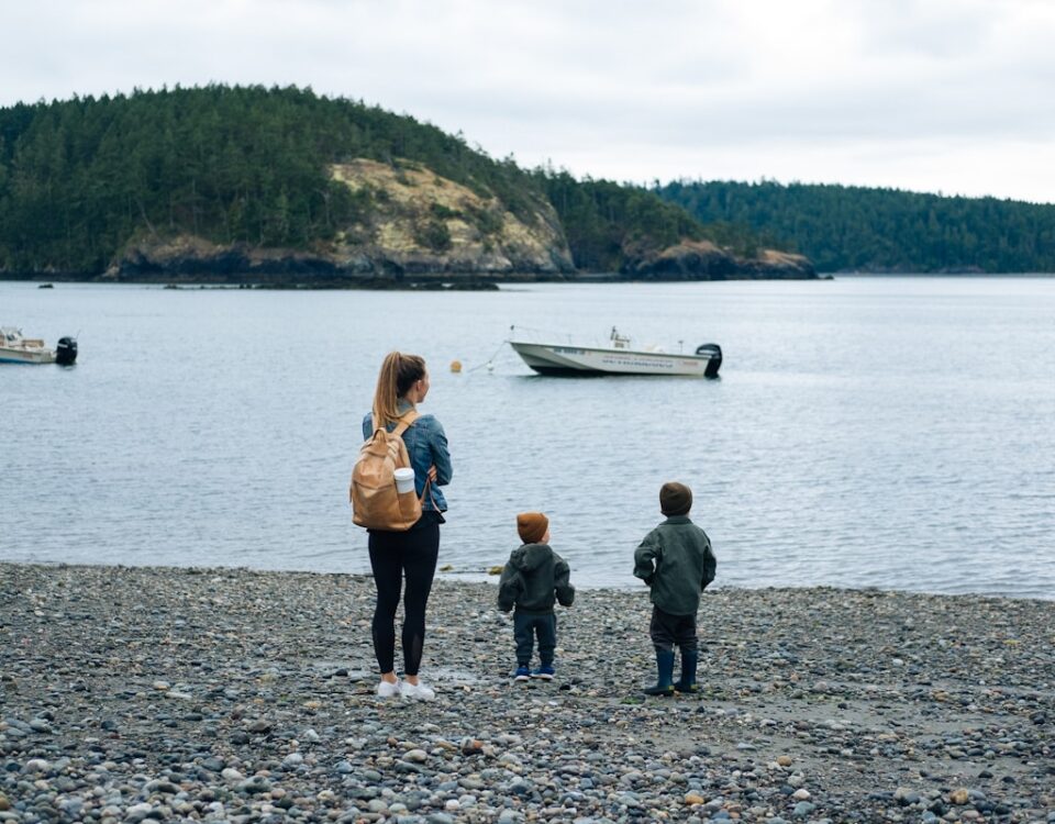 2 women and 2 men standing on shore during daytime