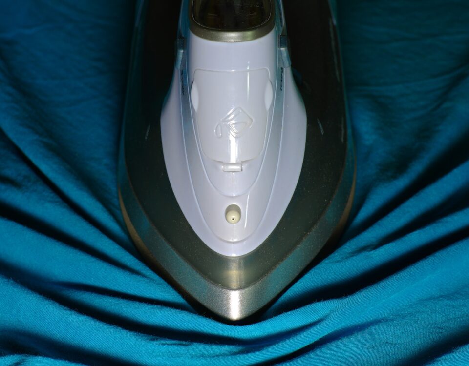 a close up of an iron on a blue cloth