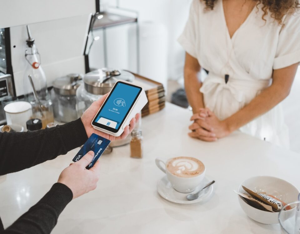 Máquinas de pagamento: aliadas na gestão de despesas empresariais woman standing and holding smartphones