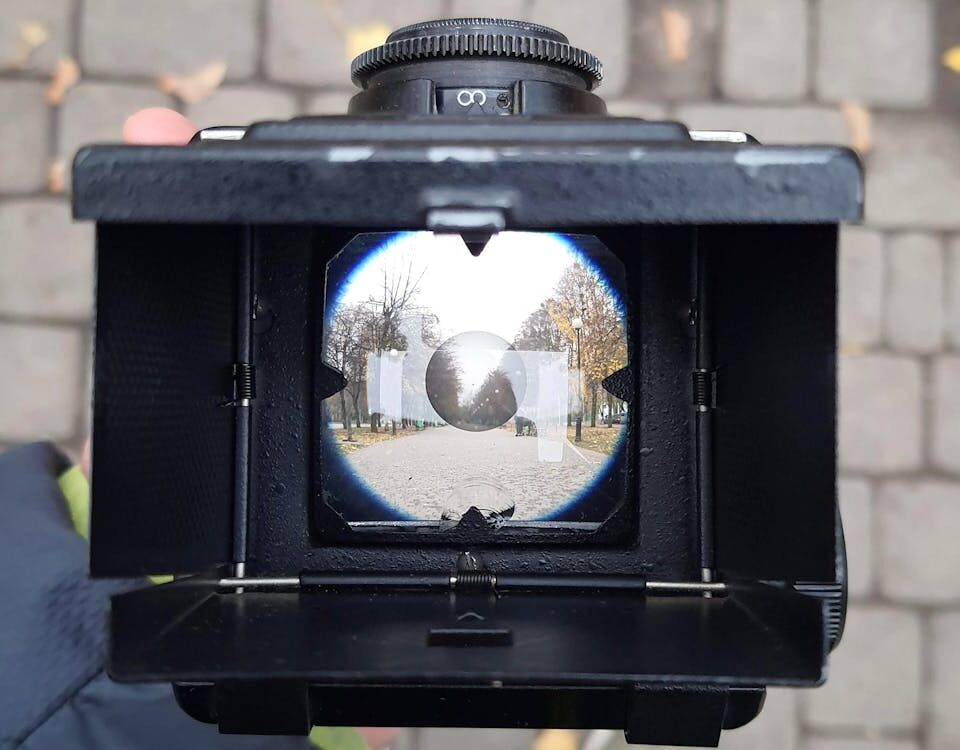 A creative shot through a vintage camera lens capturing a Kharkiv street. Artistic and intriguing perspective.